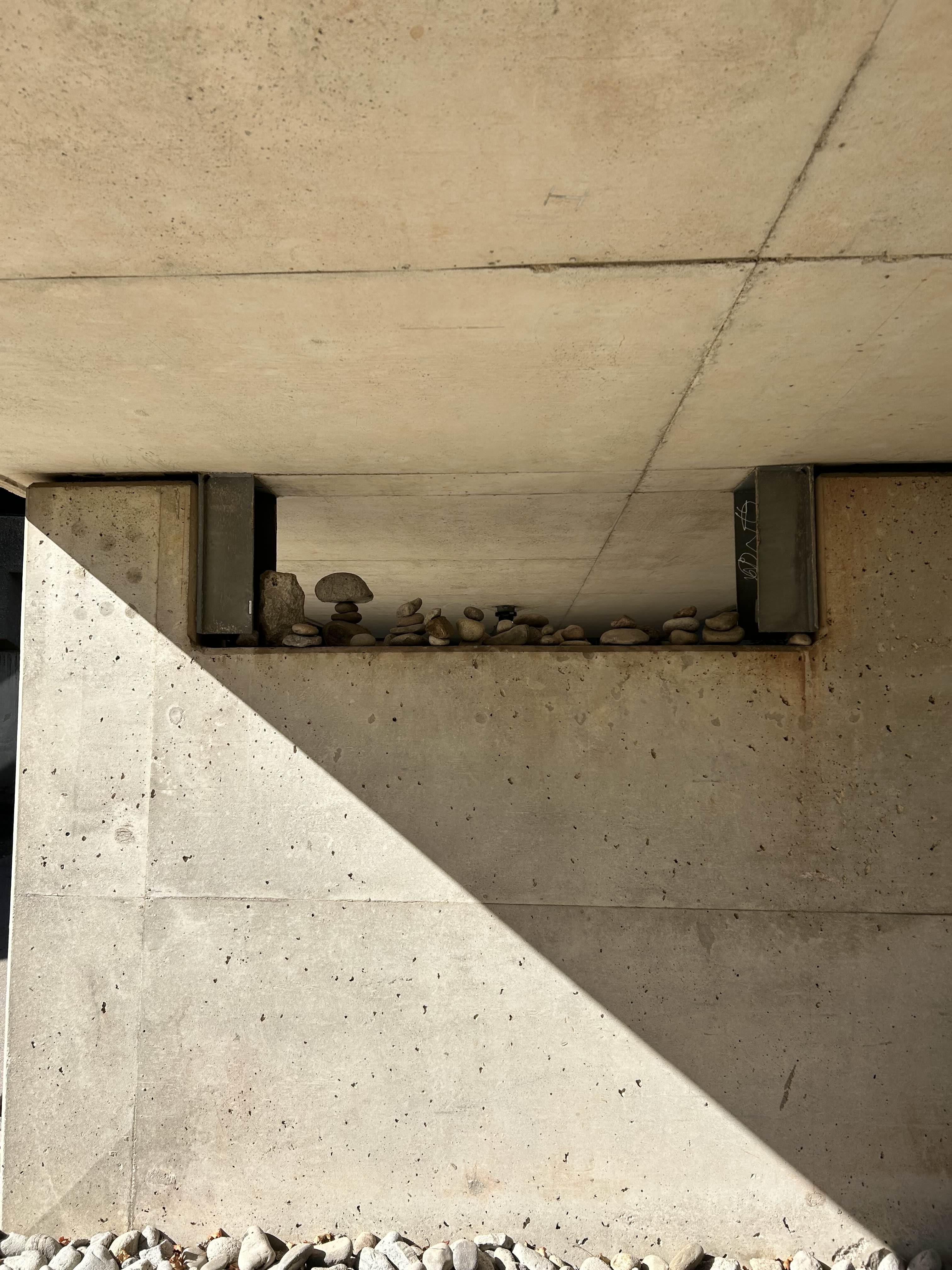 rocks lined up under a bridge